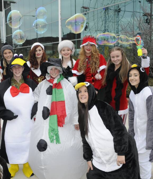 CHRISTMAS IN JULY: Students from Kelso High School's Cirkus Surreal all dressed up for their fun street theatre performances at the Bathurst Winter Festival on Saturday night. Photo: CHRIS SEABROOK 070216cwinfest1