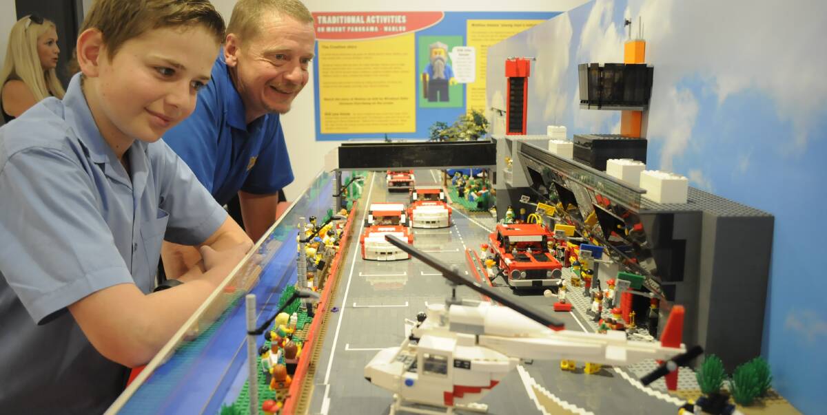 GREAT EXHIBIT: Will Starkey (11) and his dad, Pete, having a close look at the Pit Straight model made of LEGO. It is on display at Bathurst Regional Art Gallery (BRAG) until the end of January. Photo: CHRIS SEABROOK 113016clego1