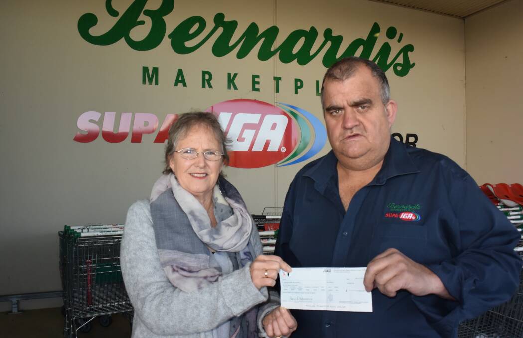 DONATION: Bathurst Child and Family Network (BCFN) chairperson Annette Meyers received a cheque from Bernardi's IGA manager Geoff Bottom. Photo: RACHEL FERRETT