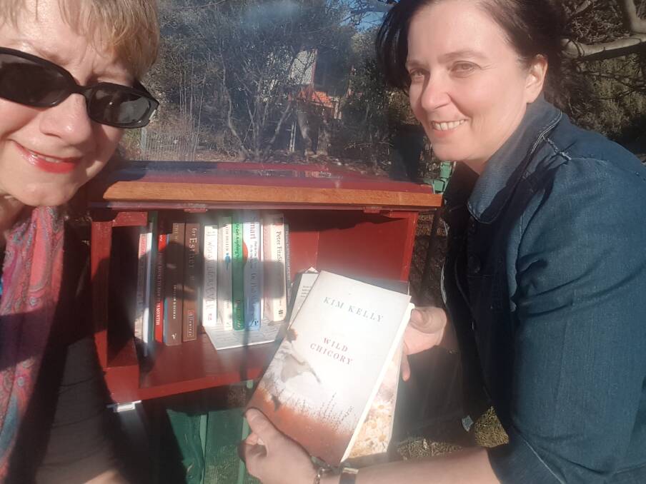 IT WORKS: Writer Margaret Paton with Millthorpe author Kim Kelly at the Street Library she launched in Blayney. 