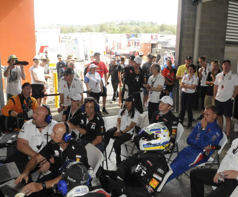 POPULAR EVENT: Spectators and officials crowded the garages to watch the support crews of the drivers carry out their work during the Bathurst 12 Hour endurance race on Sunday. Photo: CHRIS SEABROOK 020517crowd1