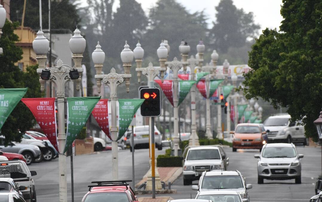 DECORATIONS: The lamp standards in the central business district have Christmas banners on them this year after Bathurst Regional Council drew criticism last year for its lack of cheer. Photo: CHRIS SEABROOK 120617cxmasbanr