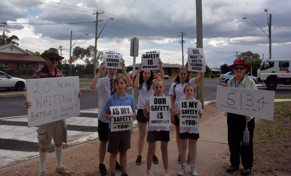 GOING STRONG: Kent and Dianne McNab with school students who want to see change at the intersection of Mitre, Suttor and Lambert streets. Photo: RACHEL CHAMBERLAIN