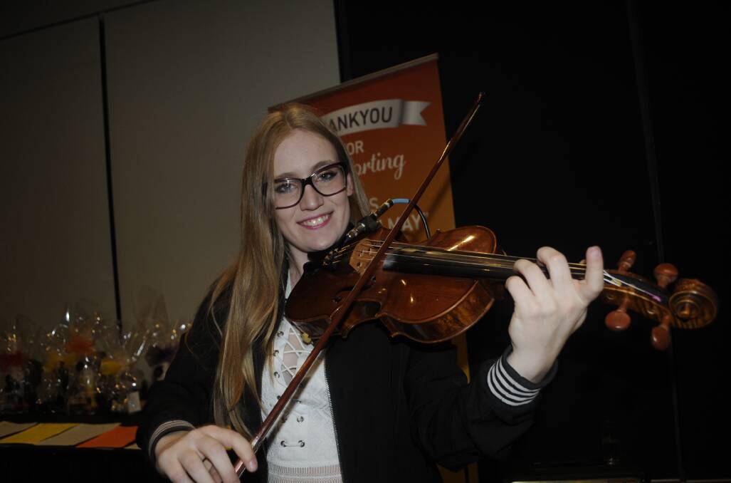 SNAPSHOT: Niamh Ann provided background music at the Mel's Go Grey in May charity dinner at Rydges. Photo: CHRIS SEABROOK 052717cgrey10