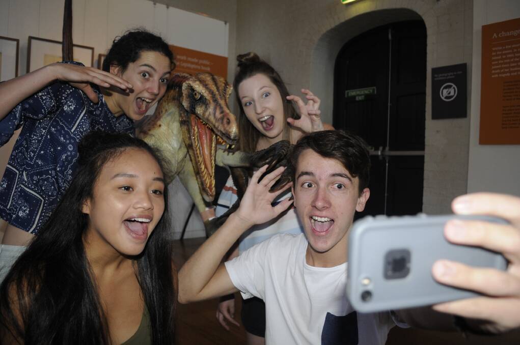 SNAPPING THEIR BEST SHOT: Marinelle Crisologo, Sarah Driver, Chelsea Stephens and Ben Clayton took a selfie with a dinosaur at the Australian Fossil and Mineral Museum in 2017. Photo: CHRIS SEABROOK 011717cself