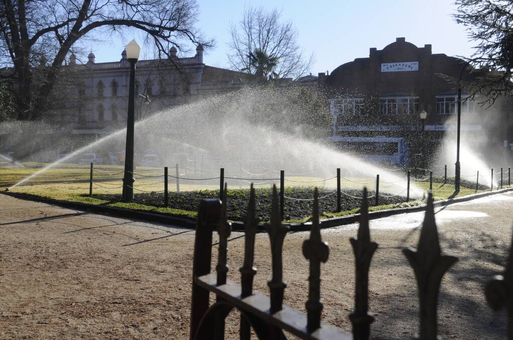 SNAPSHOT: Monday's afternoon sun highlighted the flowerbeds and lawns in Machattie Park being watered. Photo: CHRIS SEABROOK 062617csnap