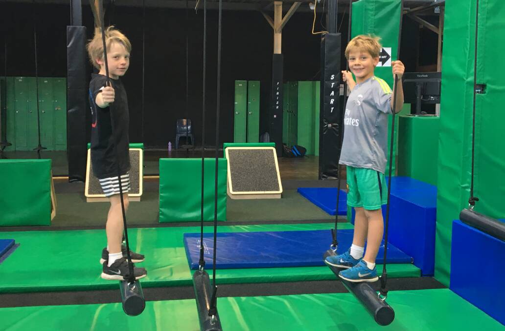FUN: Rafferty Davis, left, and Ollie Daniels, both seven, negotiate one of the obstacles in the Ninja Parc during a school holidays kids' session.
