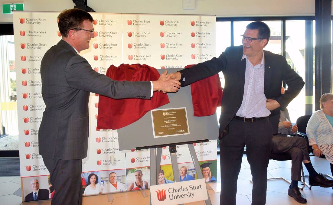 HAPPIER OCCASION: Member for Calare Andrew Gee and CSU vice-chancellor Andrew Vann celebrate the opening of the engineering building at CSU's Bathurst campus in October. Photo: RACHEL CHAMBERLAIN