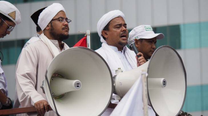 Rizieq Shihab (with microphone) speaks at a protest in January. He has now been named as a suspect by police. Photo: Dewi Nurcahyani