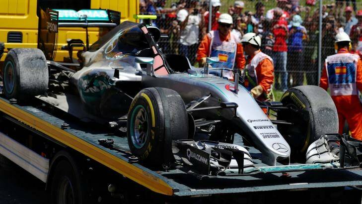 The car of Nico Rosberg of Germany and Mercedes is removed from the Spanish circuit. Photo: Clive Mason