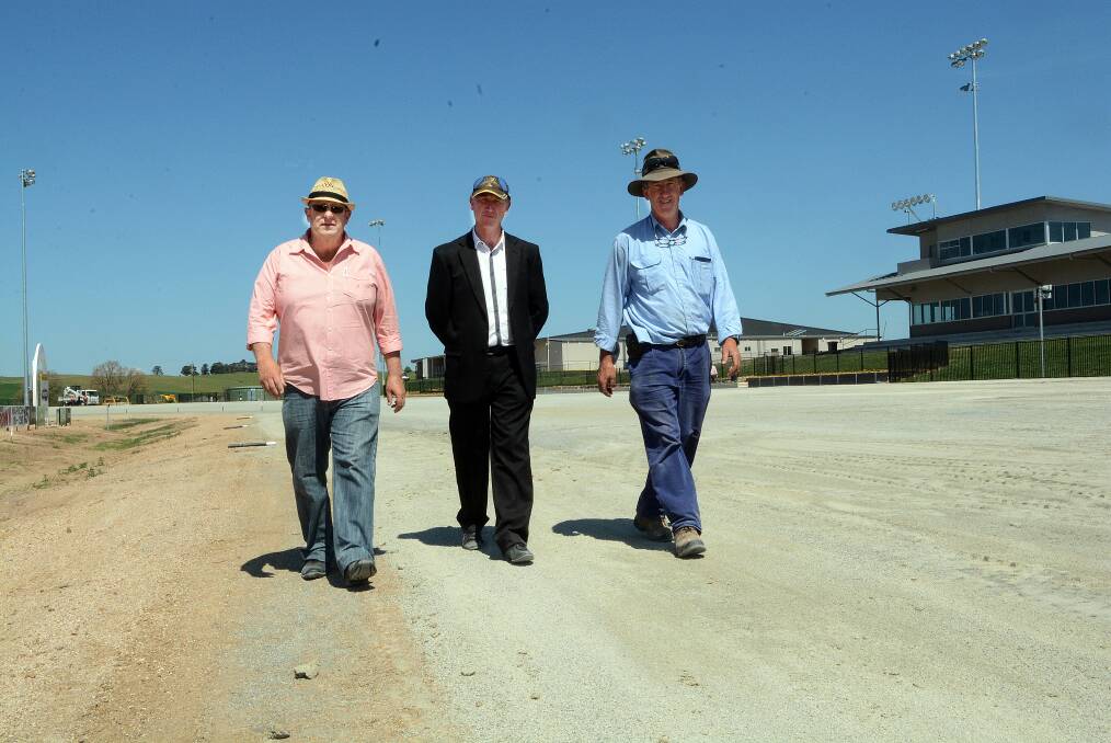 TEETHING PROBLEMS: Bathurst Harness Racing Club president Mark Collins, CEO Danny Dwyer and groundsman Tony Hagney at the new paceway yesterday after the announcement was made to cancel the scheduled meeting. Photo: PHILL MURRAY 	102214ptrack4