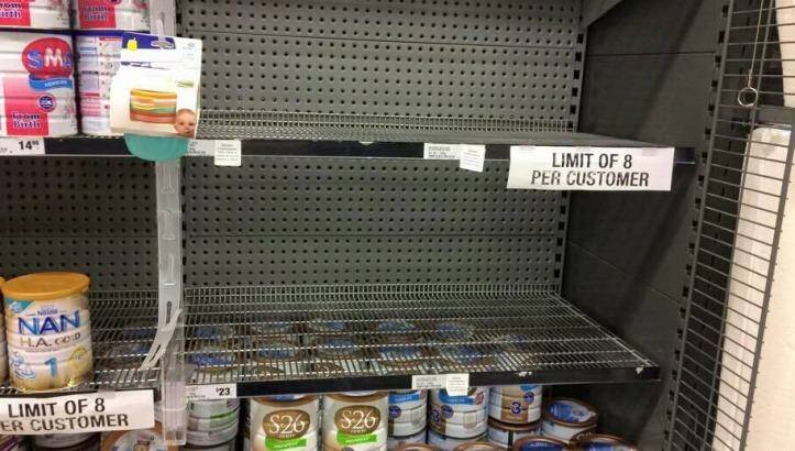A Woolworths shelf emptied of popular Australian infant formula brands. The supermarket has imposed an eight-tin limit. Photo: Supplied