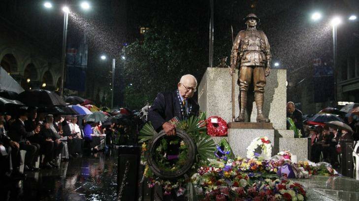 Wal Scott-Smith endures the heavy rain at the  Anzac Day Dawn Service at Martin Place in 2011. Photo: Nick Moir