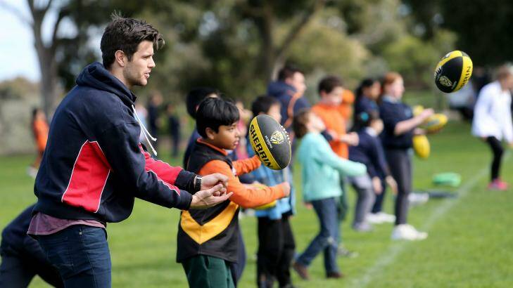 Richmond captain Trent Cotchin conducts a football clinic with children participating in the Australia Post Multicultural School Program. Photo: Pat Scala