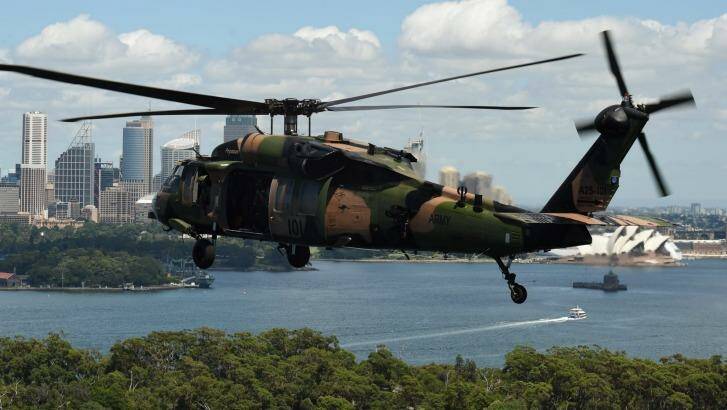 One of two Black Hawk helicopters from the Australian Army's 6th Aviation Regiment fly over Sydney Harbour.  Photo: Kate Geraghty