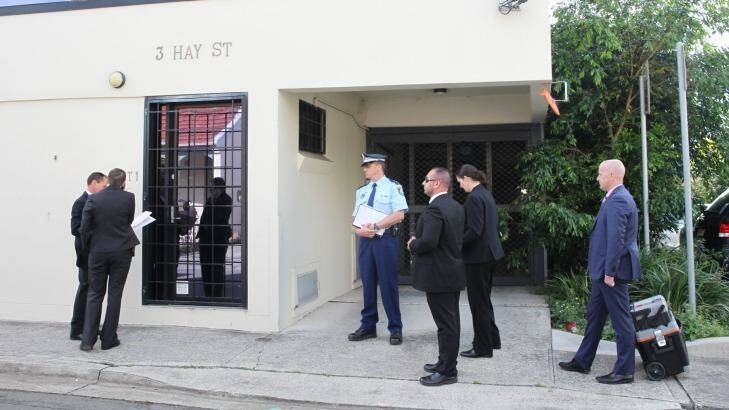 Police waiting to enter Sam Ayoub's office in Sydney.  Photo: Louise Kennerley