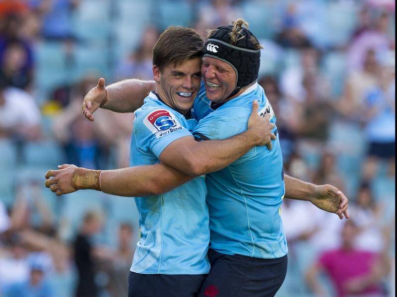 The Waratahs celebrate after a come from behind win against the Rebels.