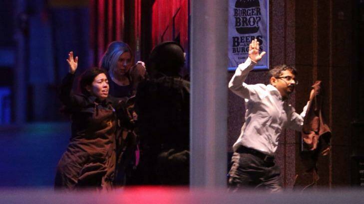 Freed hostages run from the Lindt Chocolat Cafe in Martin Place. Photo: Andrew Meares