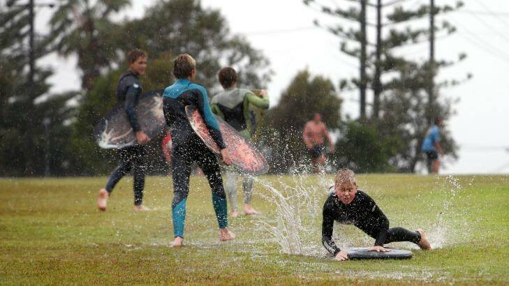 Kids making the most of the wet weather at Dawes Park, Barrack Point on Saturday. Photo: Sylvia Liber