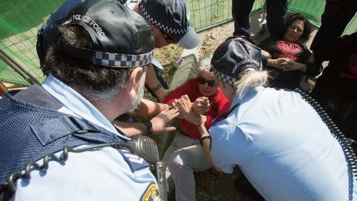 A protester is physically removed by police at St Peters on Friday. Photo: Cole Bennetts