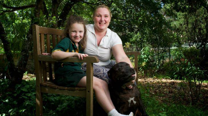 Breast cancer sufferer Melanie Cage relaxes at her home in Lawson with her daughter Shaylee and dog Max.
 Photo: Wolter Peeters