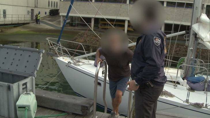 Hamish Thompson is arrested by police after they allegedly seized 1.4 tonnes of cocaine from the yacht Elakha. Photo: Australian Federal Police