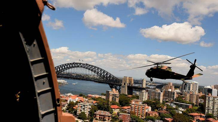 One of two Black Hawk helicopters from the Australian Army's 6th Aviation Regiment fly over Sydney Harbour during a training exercise.  Photo: Kate Geraghty