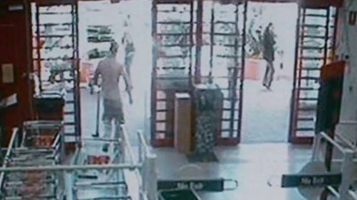CCTV footage from Bunnings Warehouse shows a man leaving with a mattock in his left hand.  Photo: Supplied