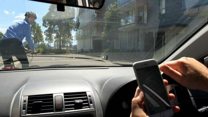 Driven to distraction: hands-free phones are just as distracting as hand-held ones for drivers Photo: Janie Barrett