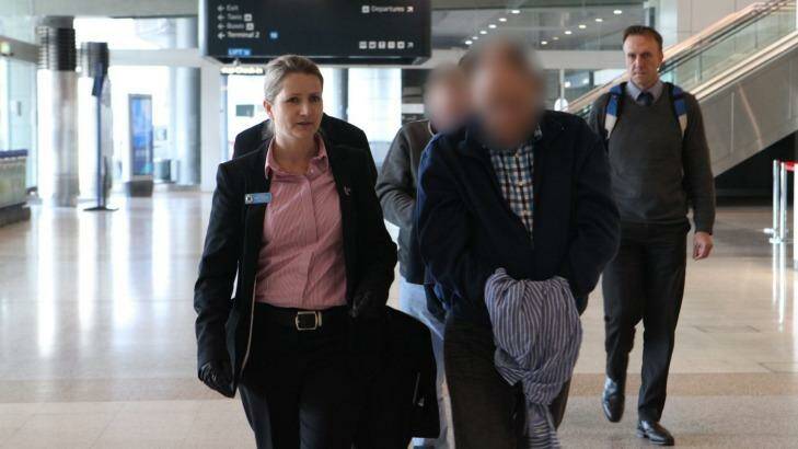 The two suspects, with their faces obscured here, arrive at Sydney Airport, escorted by police. Photo: NSW Police