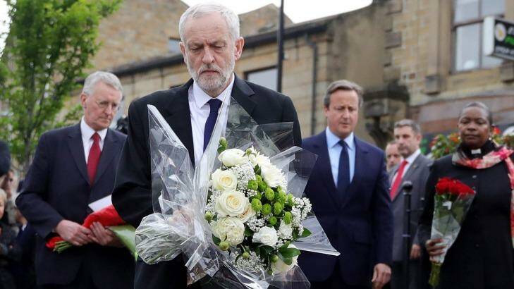 Labour leader Jeremy Corbyn, front, is flanked by the MP for Leeds Central Hilary Benn, Prime Minister David Cameron and the Chaplain to the Speaker of the House of Commons Reverend Rose Josephine Hudson-Wilkin as they lay flowers in memory of Jo Cox. Photo: Christopher Furlong/Getty Images