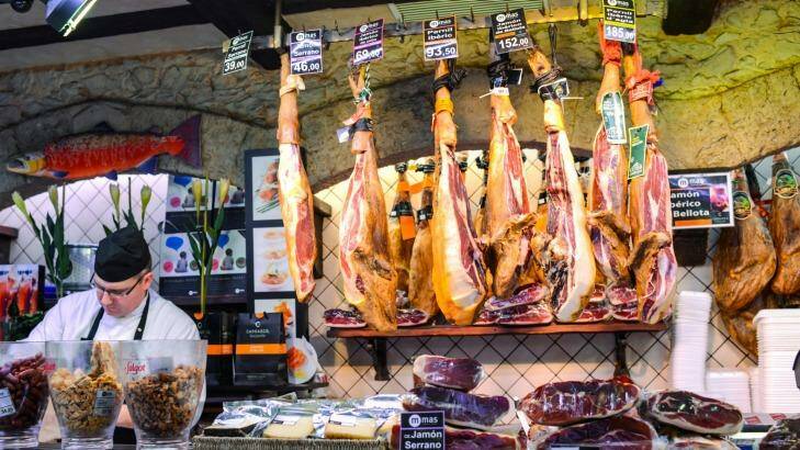 Divine jamon: Serrano and Iberian ham at La Boqueria food market, Barcelona, Spain.  Photo: iStock