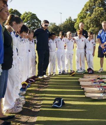 Tribute: Concord Briars Gold and Ryde Hunters Hill Swashbucklers players had a minute of silence for Phillip Hughes before the Under 11s match on Saturday. Photo: James Brickwood