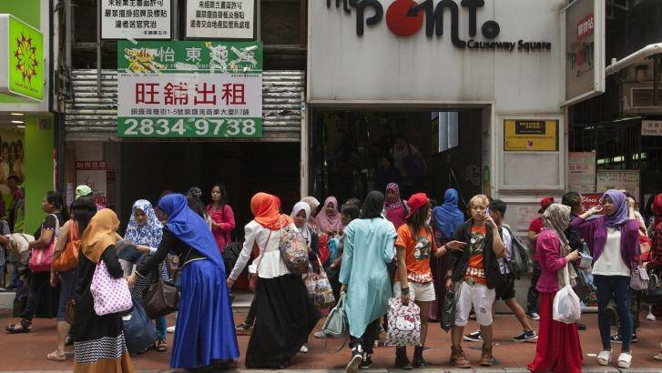 Indonesian domestic helpers on their day off in Causeway Bay, Hong Kong. Photo: Alex Hofford