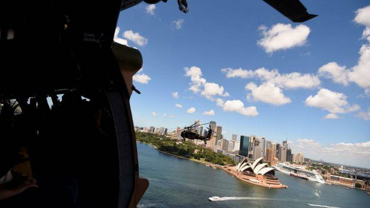One of two Black Hawk helicopters from the Australian Army's 6th Aviation Regiment flies towards the Sydney Opera House  during a training exercise.  Photo: Kate Geraghty