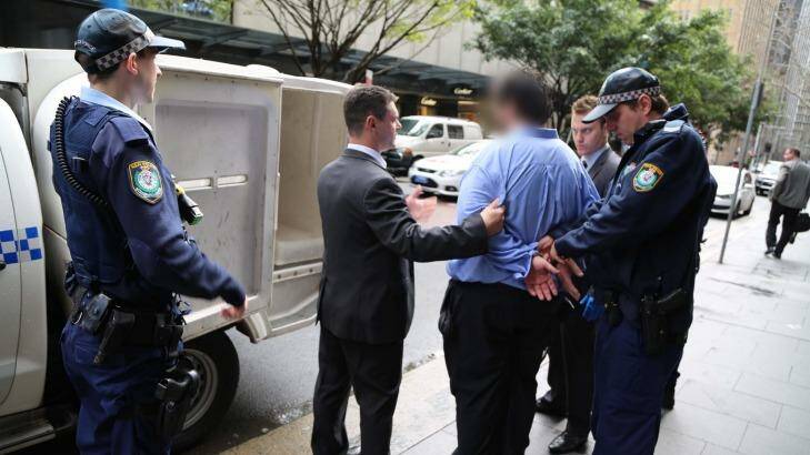 Police lead the 34-year-old man from a Martin Place office. Photo: Supplied