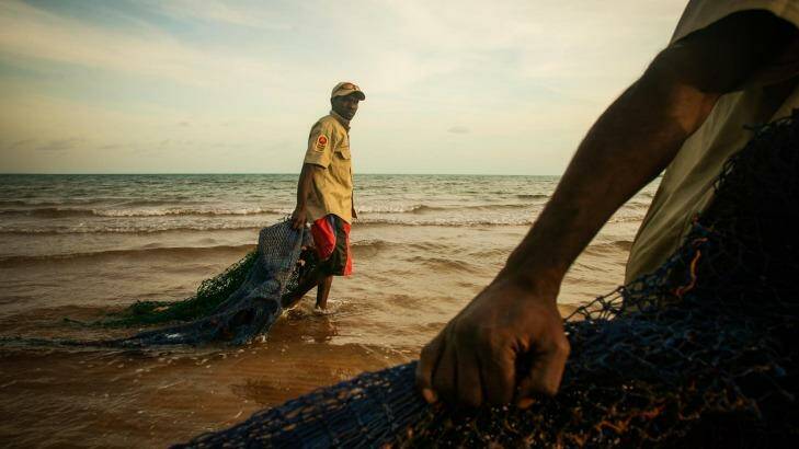 Ranger Dukpirri Marwali pulls ghost nets discarded from fishing boats ashore in the Laynhapuy Indigenous Protected Area at Yilpara on the Arnhem Land coast, NT. Photo: Glenn Campbell
