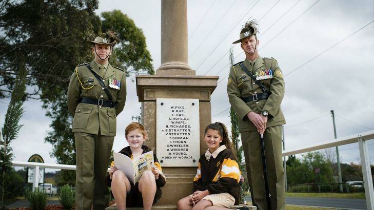 Lest we forget: Captain Nick Hornbuckle (left), Mount Hunter public school students Issac Latham and Chantel Wright and Sergeant Major Tony Lynch in front of the Mount Hunter World War I memorial. Photo: Getty Images/Christopher Pearce