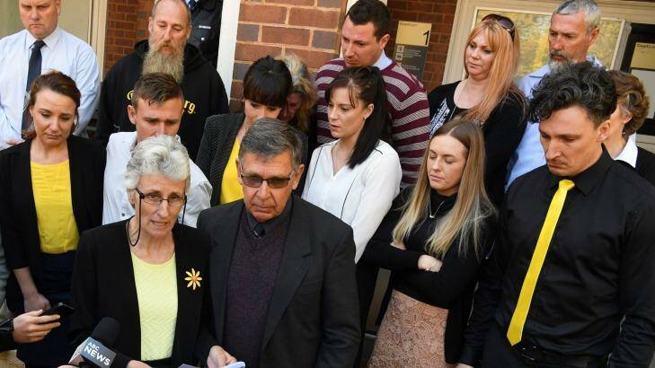 Stephanie Scott's mother Merrilyn addresses the media outside court, joined by family and friends, including Stephanie's father, Bob, and fiance Aaron Leeson-Woolley (striped jersey). Photo: Peter Rae