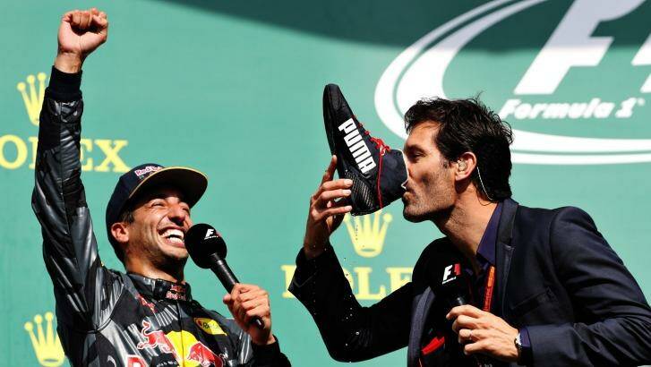 Here's to your success: Mark Webber drinks champagne from the boot of Daniel Ricciardo after the Australian driver's second-placed finish in the Belgian Grand Prix. Photo: Mark Thompson