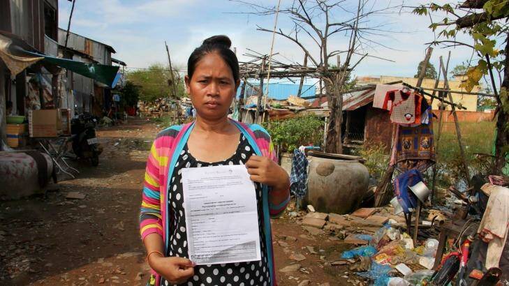 Cambodian surrogate mother Hour Vanny, holding the two-page document she signed with Fertility Solutions, operated by Australian nurse Tammy Davis-Charles.  Photo: Craig Skehan