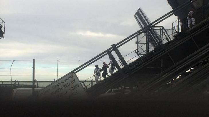 NSW Police Rescue officers escort the man off the Sydney Harbour Bridge. Photo: supplied
