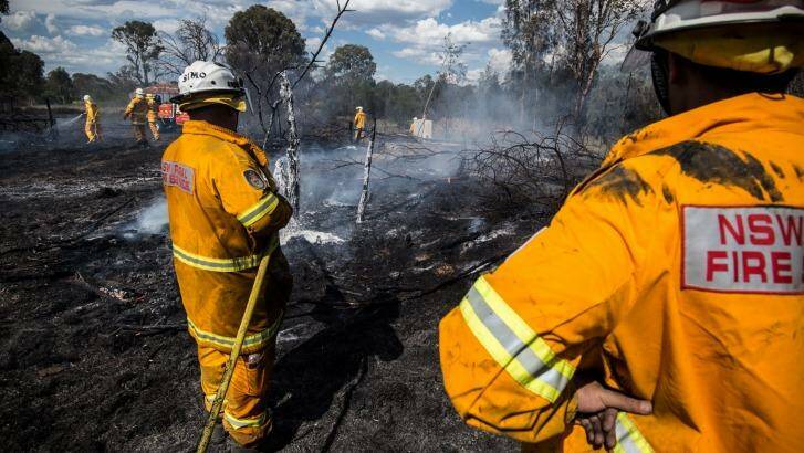 A Rural Fire Service crew extinguishes a grass fire in Luddenham on Wednesday.  Photo: Wolter Peeters