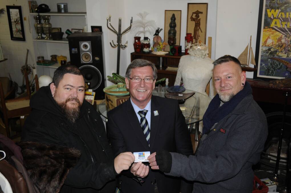 TOP ENTRY: The Naked Bud s Dave Curry and Michael Hope were presented with their prize by Bathurst Regional Council mayor Gary Rush, centre, for their display as part of the Illuminate Bathurst Winter Festival. Photo: CHRIS SEABROOK	 071315cnbud