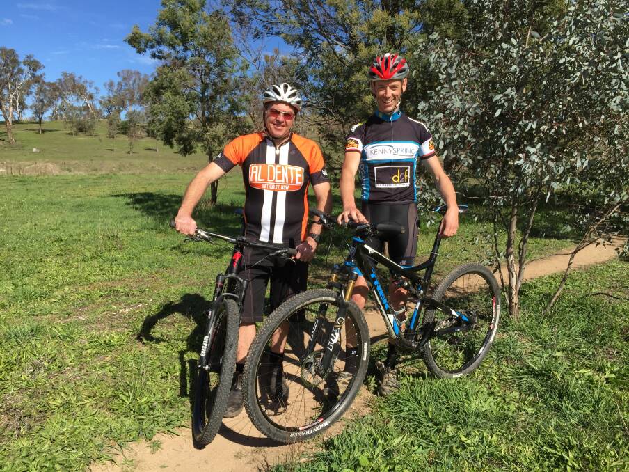 ON TRACK FOR SUCCESS: Local rider Daniel Watson, pictured with Bathurst Cycling Club president Phil Egan (left), has the experience behind him to pull off a good result when he competes in the Open Male soloist category of the Al Dente - Winter's Edge XC. Photo: SUPPLIED 052215watson