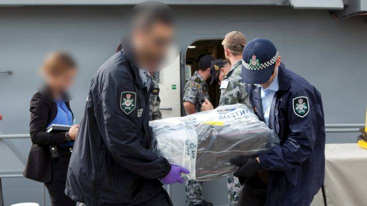 Australian Federal Police officers carry bags of cocaine. Photo: Australian Federal Police.