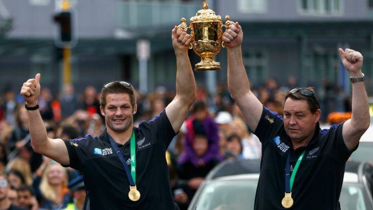 All Black captain Richie McCaw and coach Steve Hansen hold the Webb Ellis Cup aloft during the New Zealand All Blacks welcome home celebrations. Photo: Phil Walter