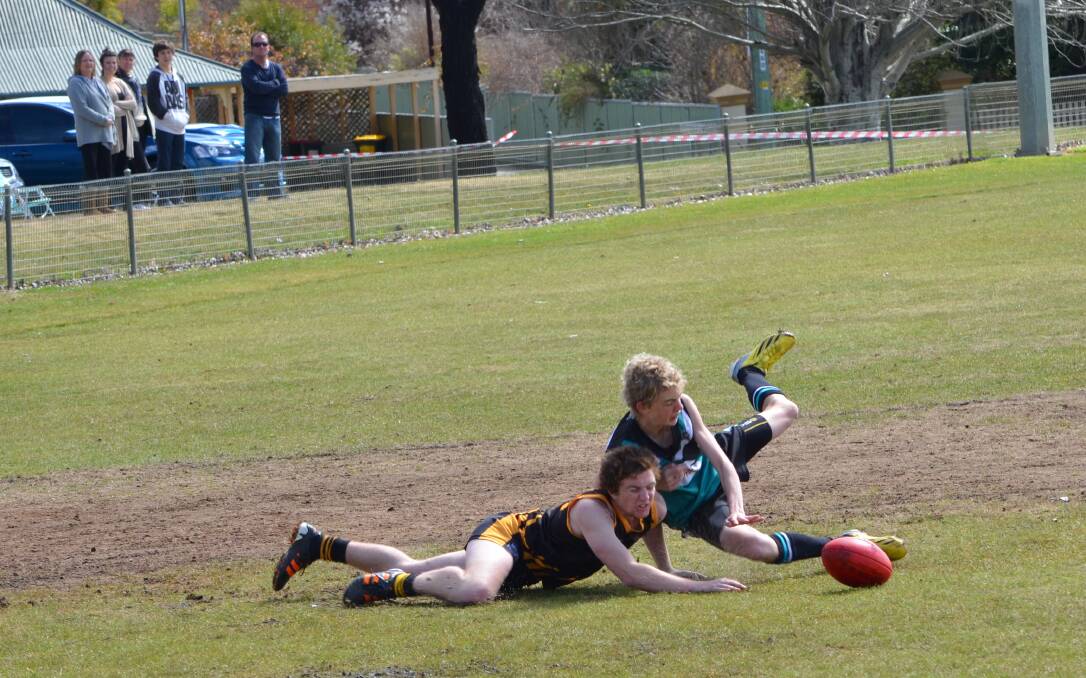 SUCCESS: Bathurst Bushranger Sam Flude (right), pictured in action during the 2013 under 18s grand, was part of the under 17s Central West AFL side which beat Northern Riverina on Saturday.	082313bushies18s12
