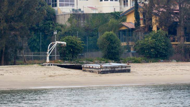 A jetty which was once submerged in water is now planted in sand and sediment, which waterfront lessees say has been washed ashore by RiverCat ferries. Photo: Janie Barrett