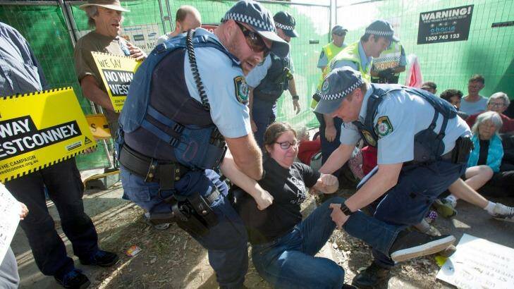 Police remove a protester from the site on Euston Road in the inner-city suburb of St Peters on Friday.  Photo: Cole Bennetts